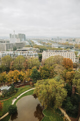 Fototapeta na wymiar Top view of a European country with lots of green trees and buildings. Image of Paris from above. French state in autumn