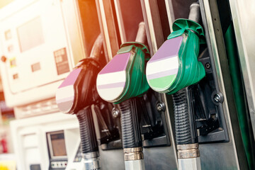 Colorful petrol and diesel nozzles of the dispenser machine at the gas fuel station