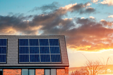 Photovoltaic solar panels on the roof of new house. Roof with solar panels