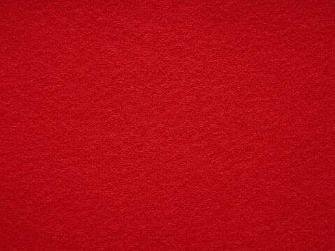 Bright red felt rough texture. Surface of felted fabric texture abstract background. Pattern for text, lettering, patchworkor other art work. Full frame backdrop wallpaper. High resolution photo.