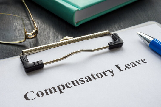 Document about Compensatory leave and pen for signing.