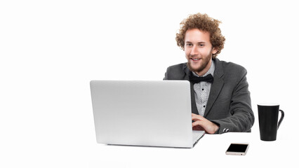 Portrait of funny businessman with bow tie who sitting and using laptop isolated on white background