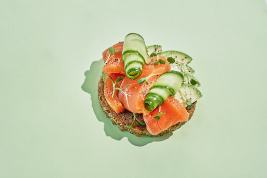 Healthy toast with spelt bread smoked salmon, fresh cucumber and avocado. Copy space