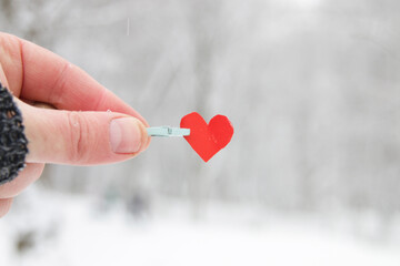 Creative winter background with blue paper heart.