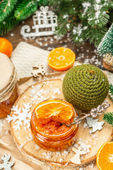 Orange marmalade or orange jam in glass jars. Sweet confiture with festive Christmas decor