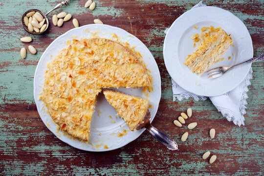 Traditional Swedish almond cake with almond flakes served as top view on a classic design plate