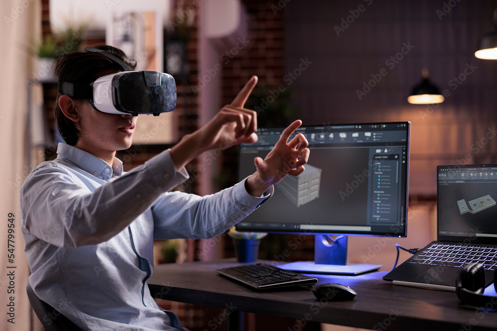 Wall mural asian man developing industrial product with computer interface and vr glasses. engineering technica