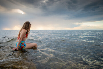 Fototapeta na wymiar A young, beautiful woman relaxes in the water of the Adriatic Sea in Croatia