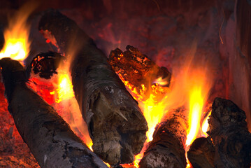 Orange fire in the fireplace. Burning firewood.