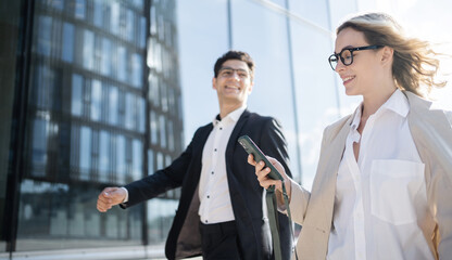 The managers are a man and a woman in business suits. Employees brainstorm people go to the office...