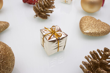 several  golden christmas ornaments on white background