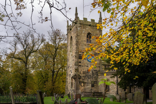 View of St Lawrence's church and the church yard in autumn, Eyam, Peak District, England