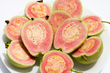 Fresh pink guava on white background.