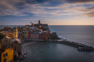 Obraz premium Vernazza village, aerial view on sunset, Seascape in Five lands, Cinque Terre National Park, Liguria Italy Europe. Long exposure picture. September 2022