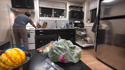 Time lapse of man cleaning kitchen, wiping, messy kitchen, house work, clean up, cooking, dishwasher. 4K 24FPS - Powered by Adobe