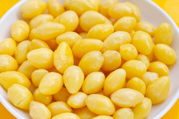 Boiled ginkgo nuts on yellow background.