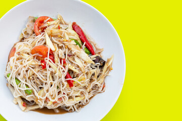 Spicy green papaya salad with vermicelli on white