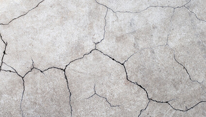 Cracked cement or concrete surface texture for background.