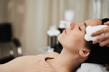 Obraz na płótnie Canvas Women's face massage with gadgets.
