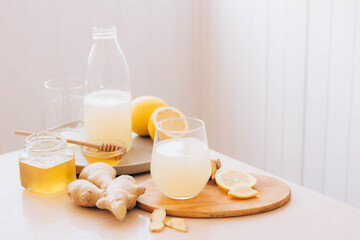 Fototapeta na wymiar Trendy drink made from fresh lemon ginger root honey in glass. Antioxidant health drink, vitamins