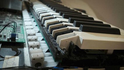 Cleaning dirty old synthesizer keys. Disassembly and keyboard repair. Keybed close up shot.