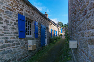 Medieval house with blue wooden shutters at the windows in the small beautiful village of Locronan, Brittany, France