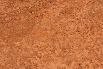 Texture of dirt floor with some cracks, used on clay tennis courts. Brick dust
