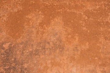 Texture of dirt floor with some cracks, used on clay tennis courts. Brick dust