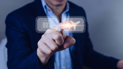 Businessman pointing finger touching to select flight by pressing touch screen airplane button,Business Airplane transportation concept