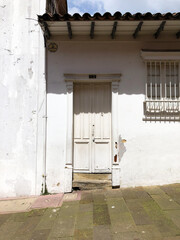 door and white house in the historic center of bogota