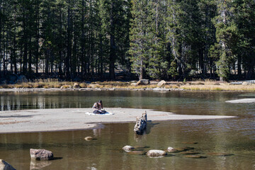 women painting on the lake