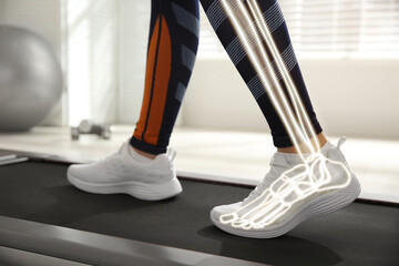 Digital composite of highlighted bones and woman training on walking treadmill indoors, closeup