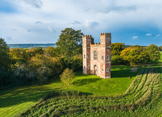 The Belvedere Tower over Powderham Park from a drone in Autumn Colors, Powderham Castle, Exeter, Devon, England