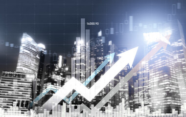As background for a financial or business concept, digital screen and financial graphs overlap on a picture of modernistic cityscape, skyscrabbers.