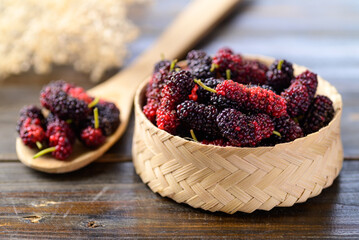 Fresh mulberry fruit in bamboo basket, Healthy organic tropical fruit