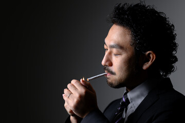 Profile of a dandy man smoking a cigarette Lighting a cigarette