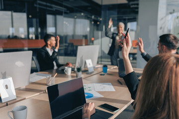 Busy multiethnic coworkers cooperating and working together at office meeting, teamwork concept