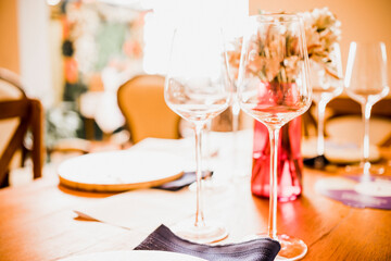 wine glasses placed on a wooden table with decoration for the celebration of a party
