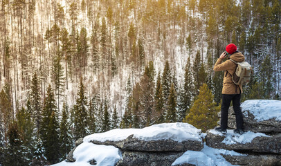 A man tourist with a phone in his hand on top far from civilization . Activity and availability of mobile communications