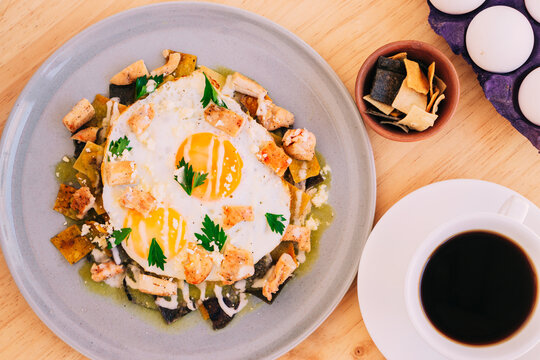 Traditional Breakfast Of Chilaquiles With Eggs, Chicken And Coffee, Aerial View. Lunch.