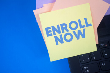 Enroll Now. Text on adhesive note paper. Event, celebration reminder message.