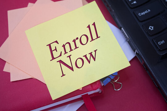 Enroll Now. Text on adhesive note paper. Event, celebration reminder message.