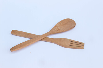 Isolated wooden spoon and fork on white background