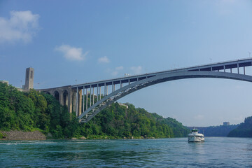 Niagara Falls, Ontario, Canada: The Rainbow International Bridge over the Niagara Gorge, the Rainbow Carillon Tower, a Maid of the Mist tourist boat.