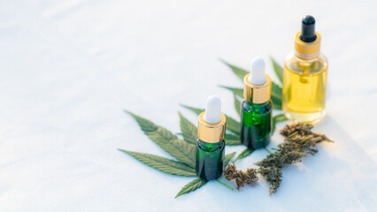 Obraz na płótnie Canvas CBD hemp oil products, cannabis flowers and cannabis leaves, medical cannabis concept