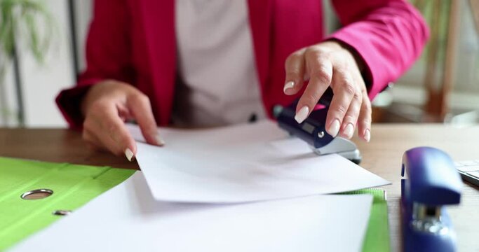 Businesswoman hand punch paper on table closeup