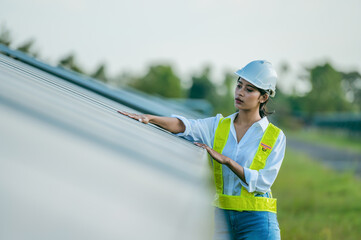 Asian young engineer female working with solar panels in station