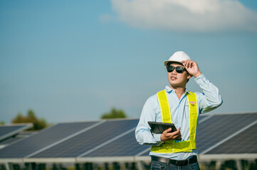 Portrait Asian young inspector engineer man in solar farm