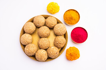 tilgul or til gul laddu or Sesame seed jaggery ball or til ke laddo with flower and haldu kumkum