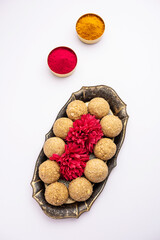 tilgul or til gul laddu or Sesame seed jaggery ball or til ke laddo with flower and haldu kumkum
